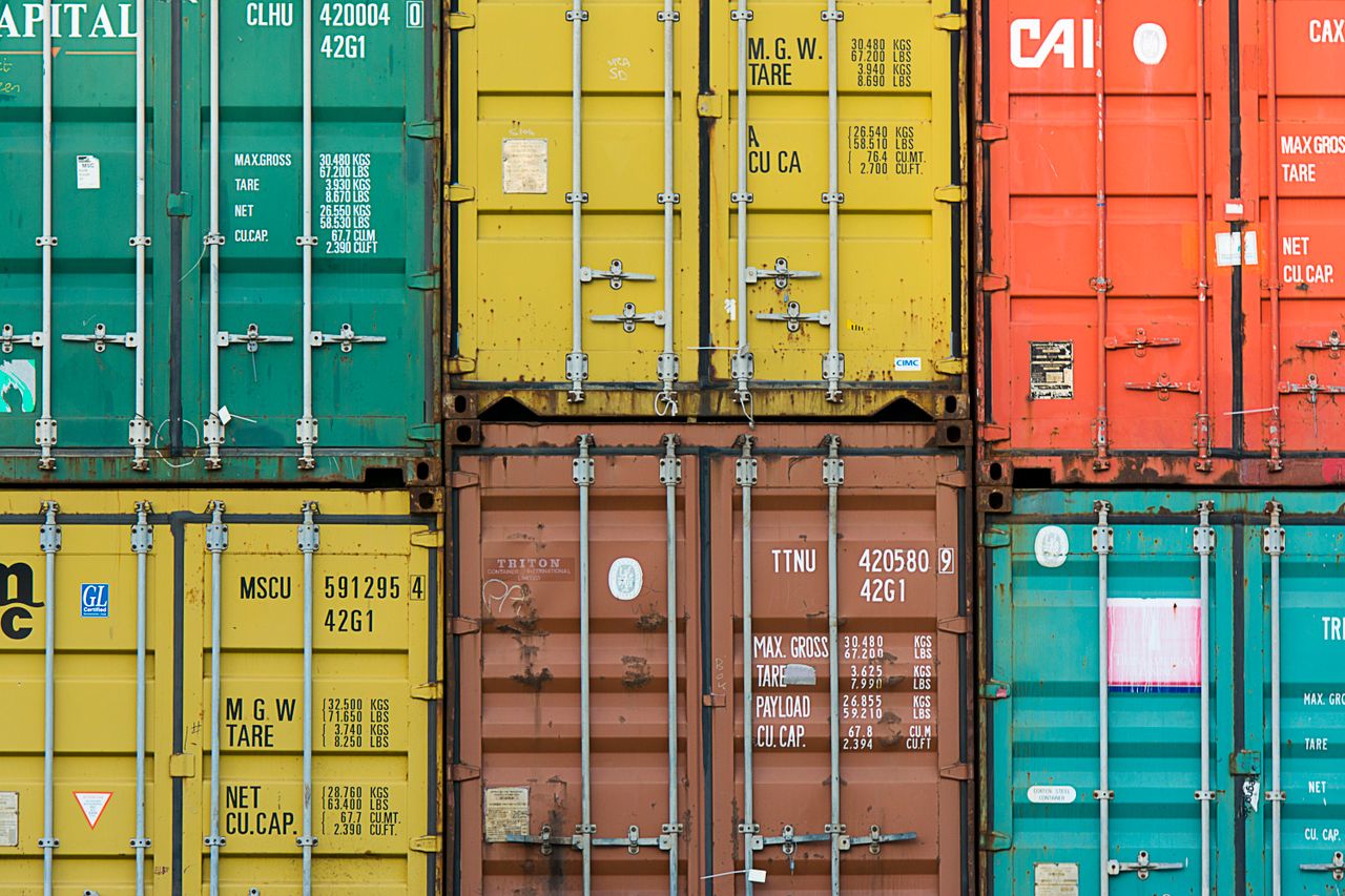 Vibrant cargo containers stacked in a shipping yard highlighting global trade.